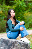 senior girl portrait sitting on a rock