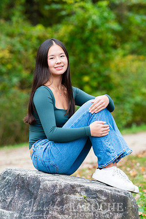 senior girl portrait sitting on a rock