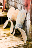 Patina‑Rich Boat Propellers at the Old Fishing Shack