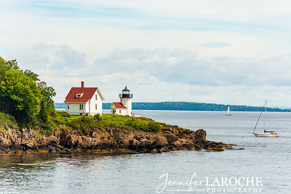 view of Camden lighthouse and sailboat