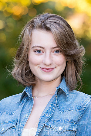 outdoor senior headshot with nature background